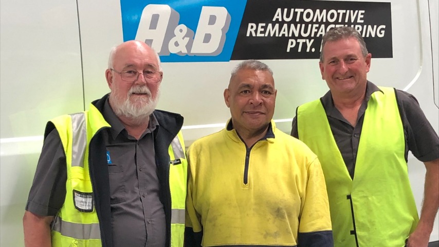 A&B Automotive team members stand in front of a branded van