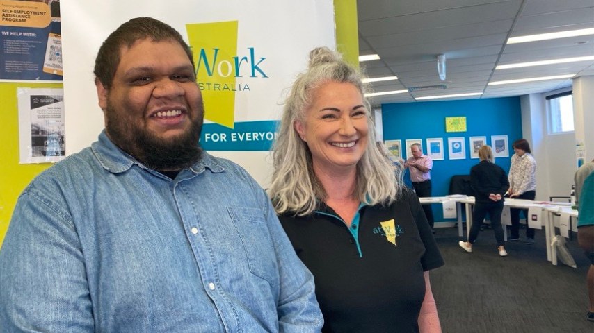 A client stands next to an atWork Australia staff member. Both are happy to be working together.